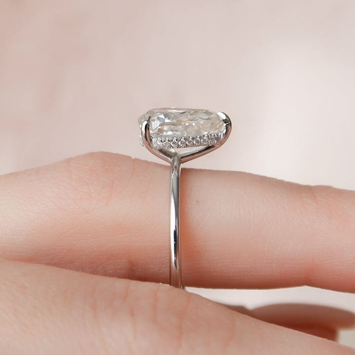 Elegant teardrop solitaire moissanite ring, angled view