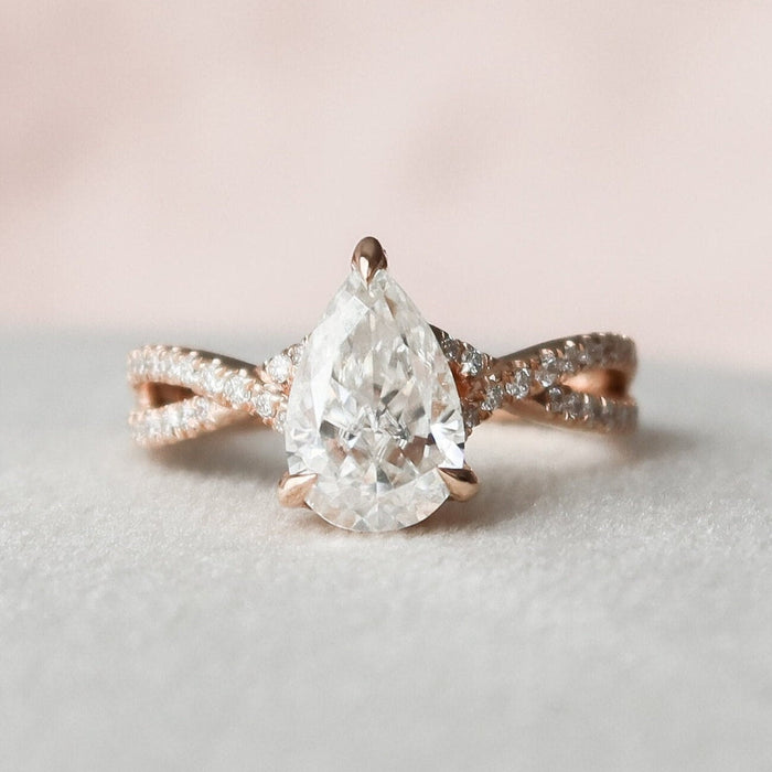 Pear shaped moissanite vintage engagement ring with twisted band in gold