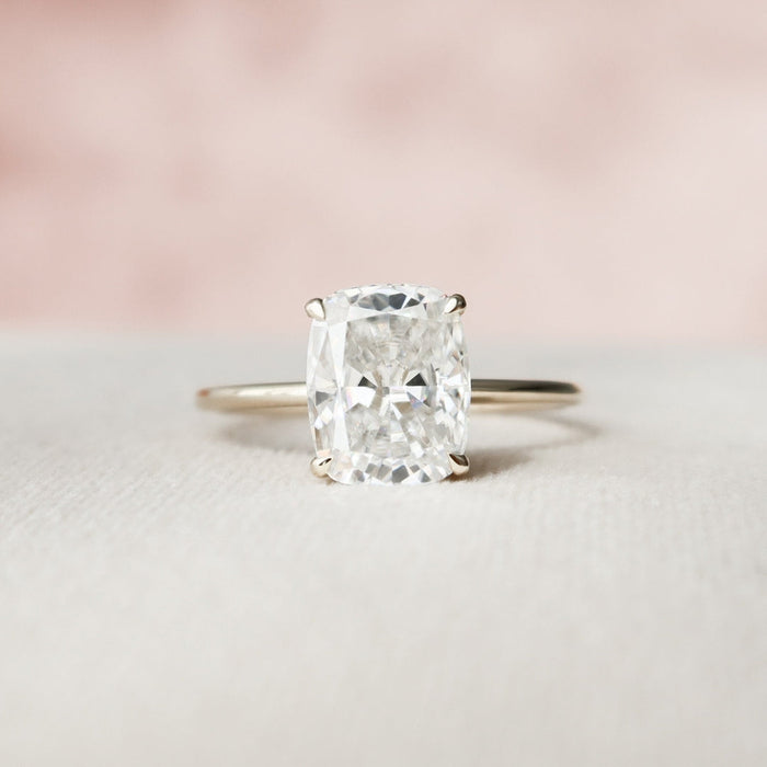 Elongated cushion cut moissanite solitaire engagement ring in gold