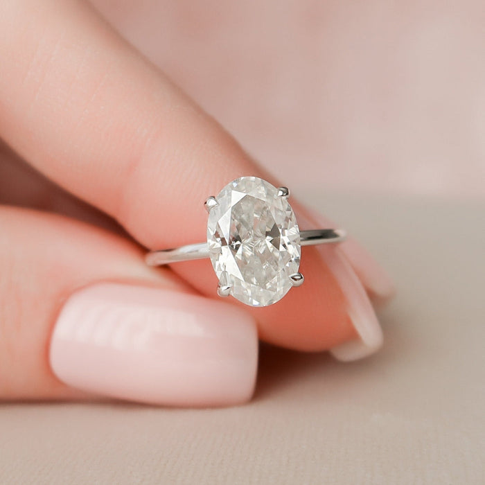 Colorless oval moissanite wedding ring, angled view