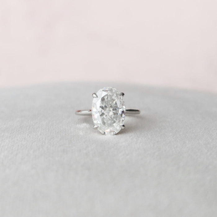 Oval moissanite engagement ring with hidden halo in gold