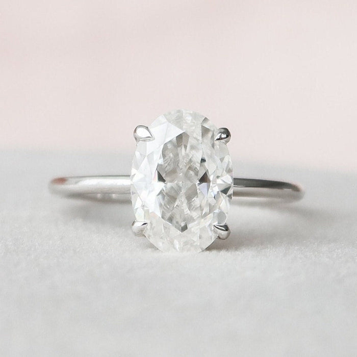 Oval cut moissanite engagement ring with 4 prong setting in gold