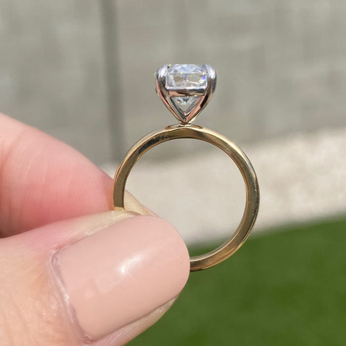 Handmade oval moissanite solitaire ring, angled view