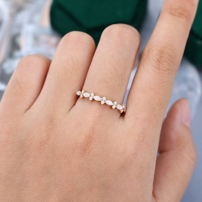 Marquise and round moissanite floral cluster wedding band worn on the finger