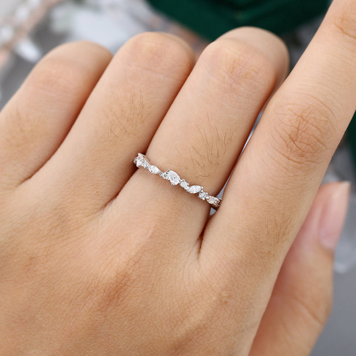 Marquise, round and pear moissanite full eternity wedding band worn on a finger