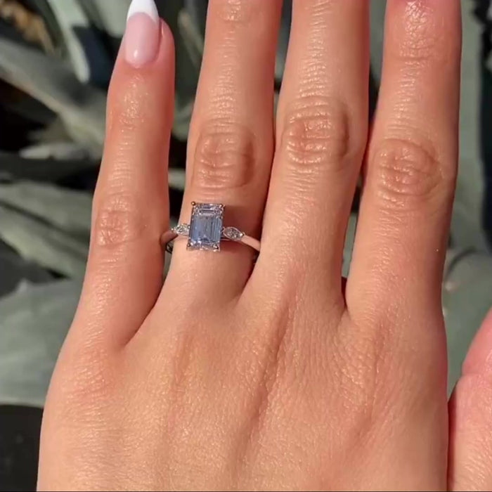 Handmade three stone emerald moissanite bridal ring, angled view