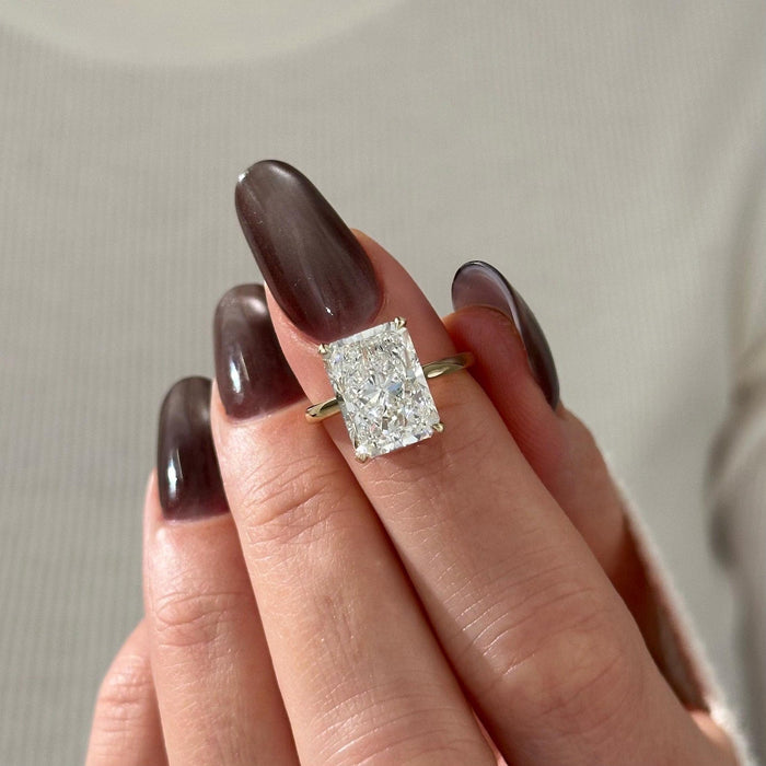 Elongated radiant cut lab grown diamond solitaire ring on a thin band