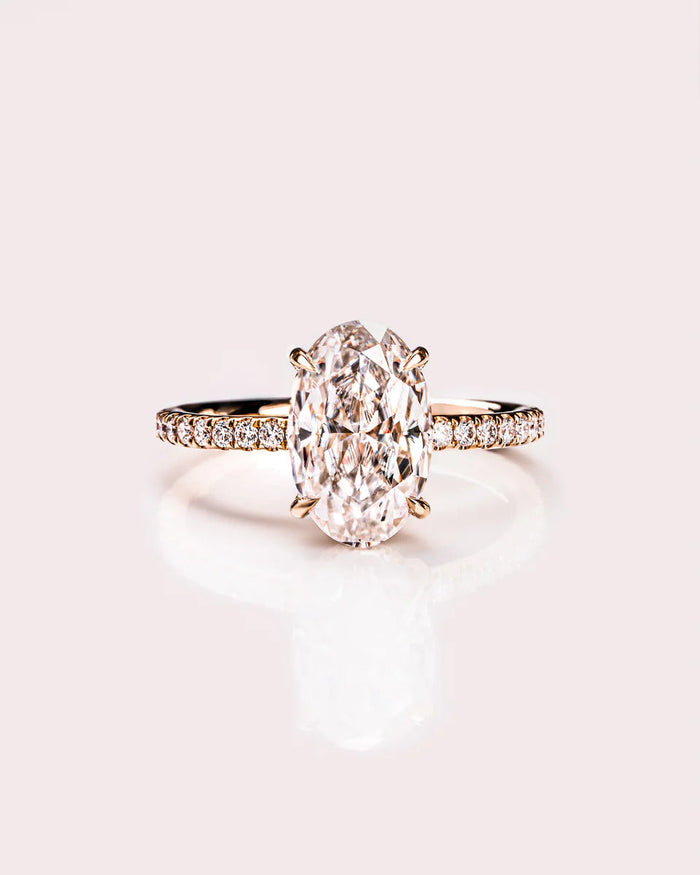 Oval cut moissanite hidden halo engagement ring with eternity band in gold