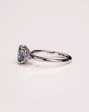Unique gold oval moissanite round cluster ring, angled view