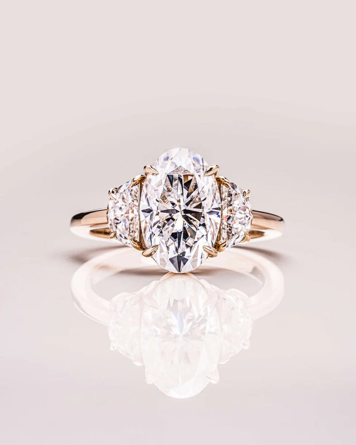Oval three stone moissanite engagement ring in gold
