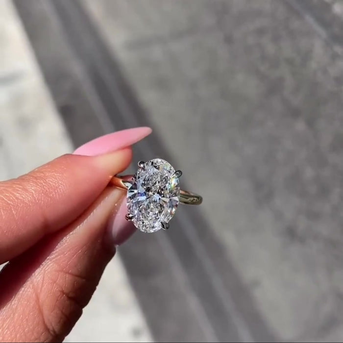 Oval cut moissanite solitaire ring with hidden halo in solid gold