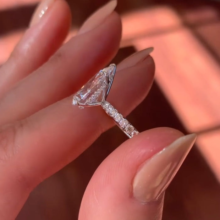 Elegant pave set pear cut moissanite ring, angled view