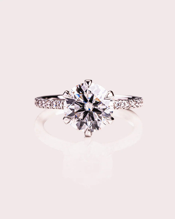 Round brilliant cut moissanite solitaire engagement ring in gold
