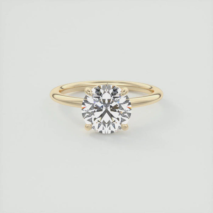 Round cut moissanite solitaire engagement ring in gold