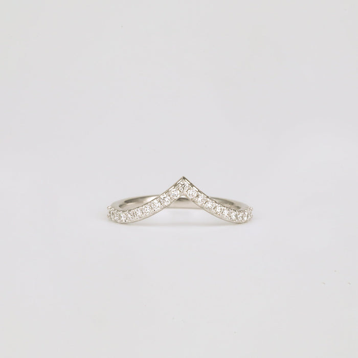 Front view of a round moissanite curved chevron wedding band
