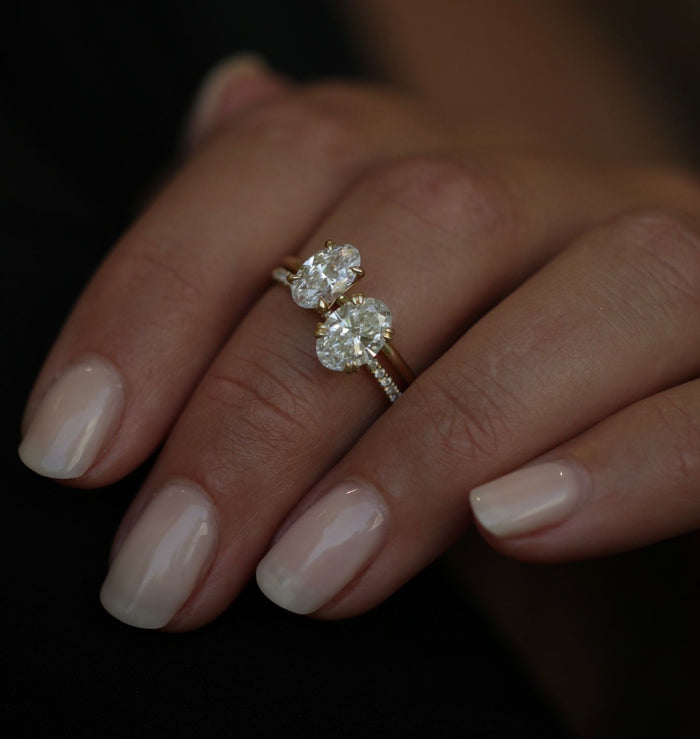 Oval solitaire pave band engagement ring worn on the hand