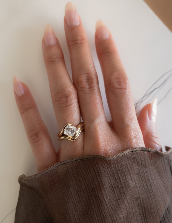 Asscher lab grown diamond bypass engagement ring and plain angled wedding band, full hand view