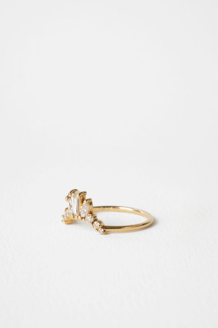 Curved crown moissanite wedding band in yellow gold, side view