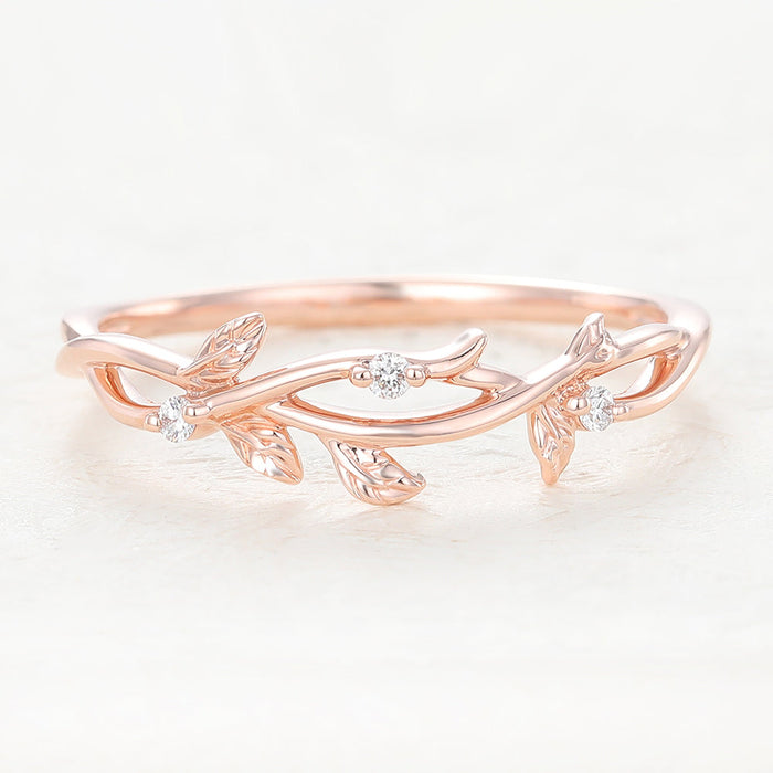 Rose gold twig and leaf wedding band with three small round moissanite stones, front view