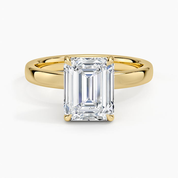 Emerald cut lab grown diamond solitaire ring in yellow gold on a domed comfort fit band, top view