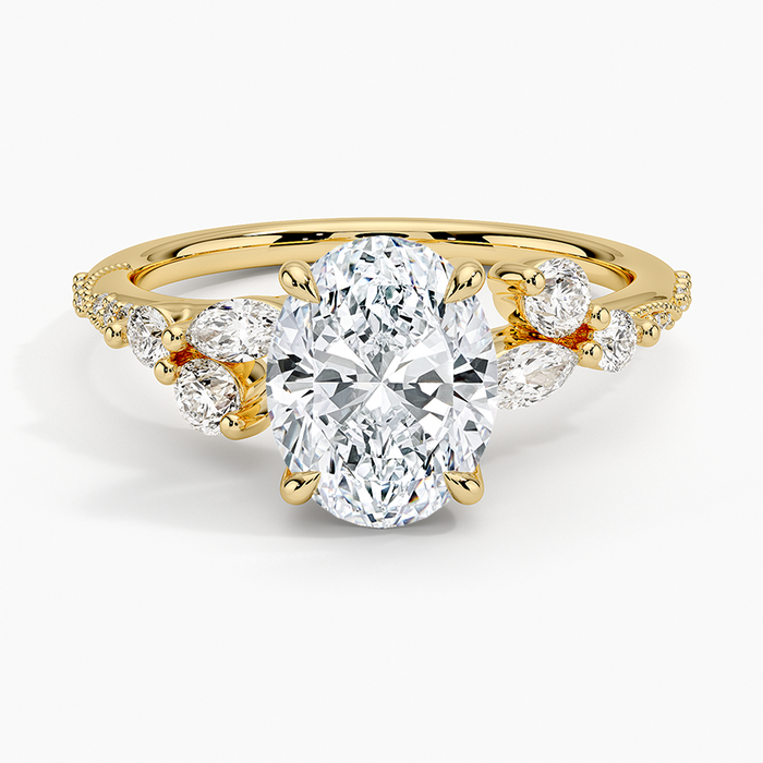 Oval cut lab grown diamond ring with scattered marquise and round clusters in yellow gold, top view