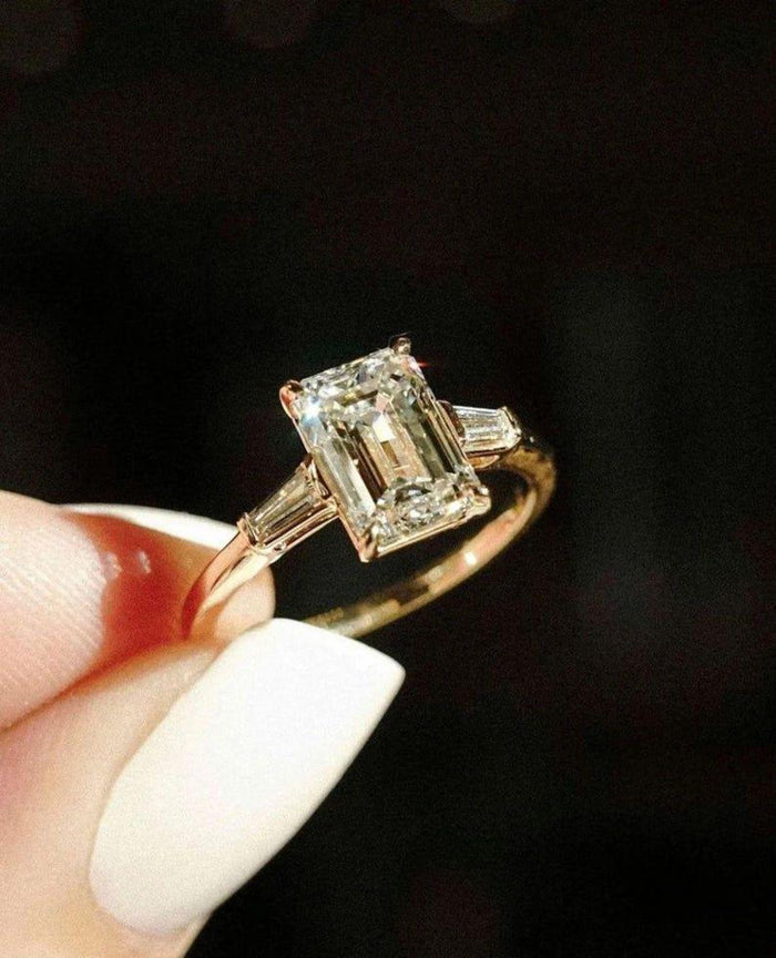 Emerald cut lab grown diamond three stone ring angled view