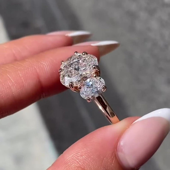 Oval cut lab grown diamond anniversary ring on hand