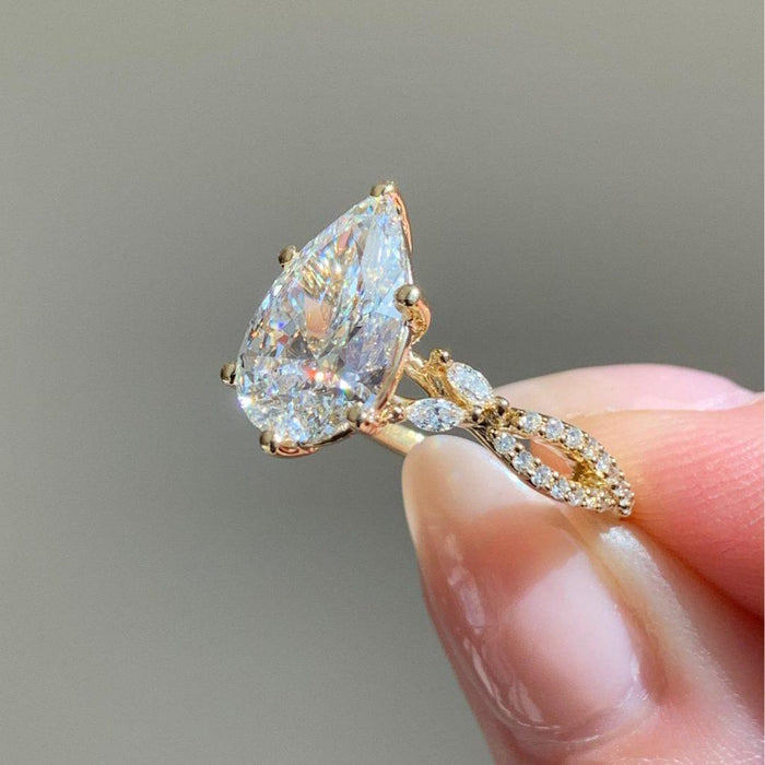 Teardrop pear diamond ring on braided two strand shank in solid gold