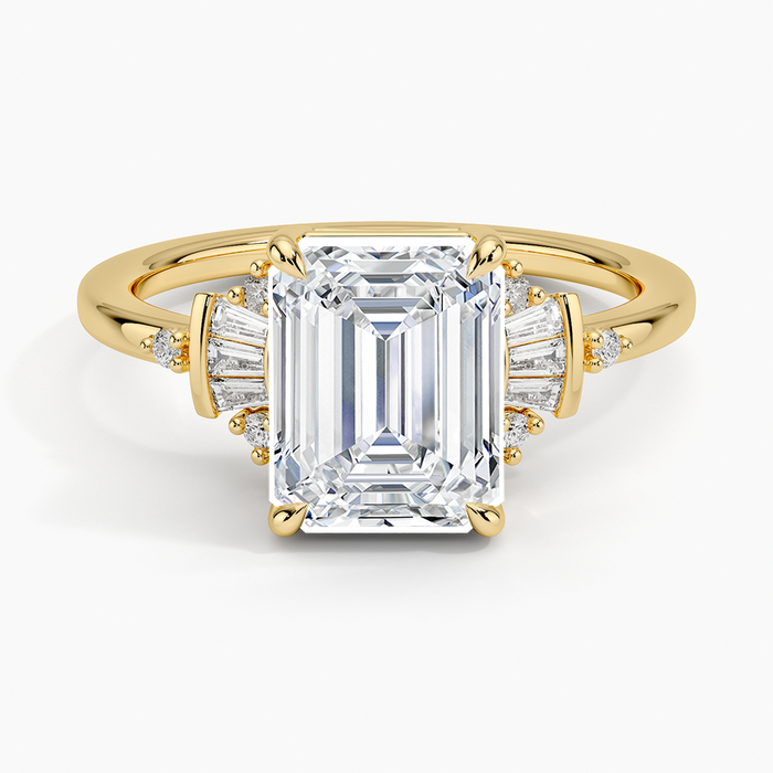 Emerald cut lab grown diamond ring in yellow gold with stacked baguettes and round accents at the shoulders, top view
