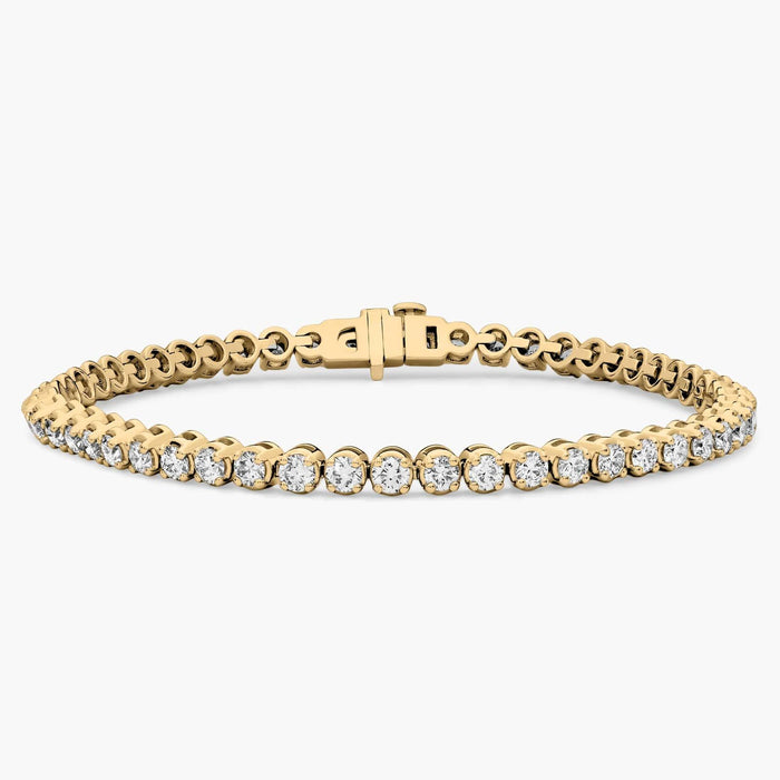 Four prong round moissanite tennis bracelet in solid gold
