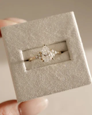 Pear solitaire accent stones ring side view