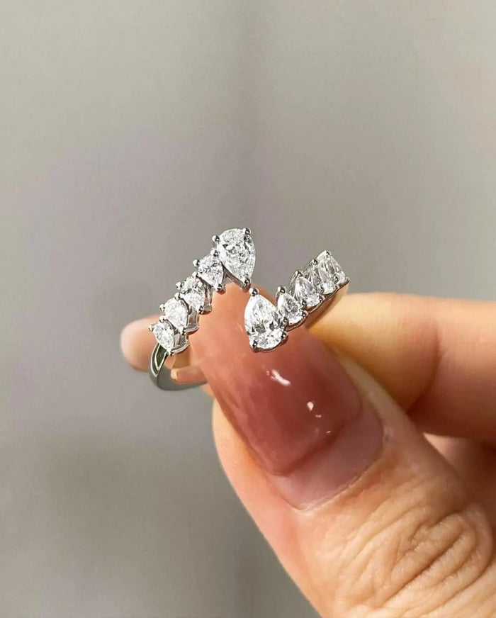 Two pear cut lab grown diamonds at the open ends of the bypass band
