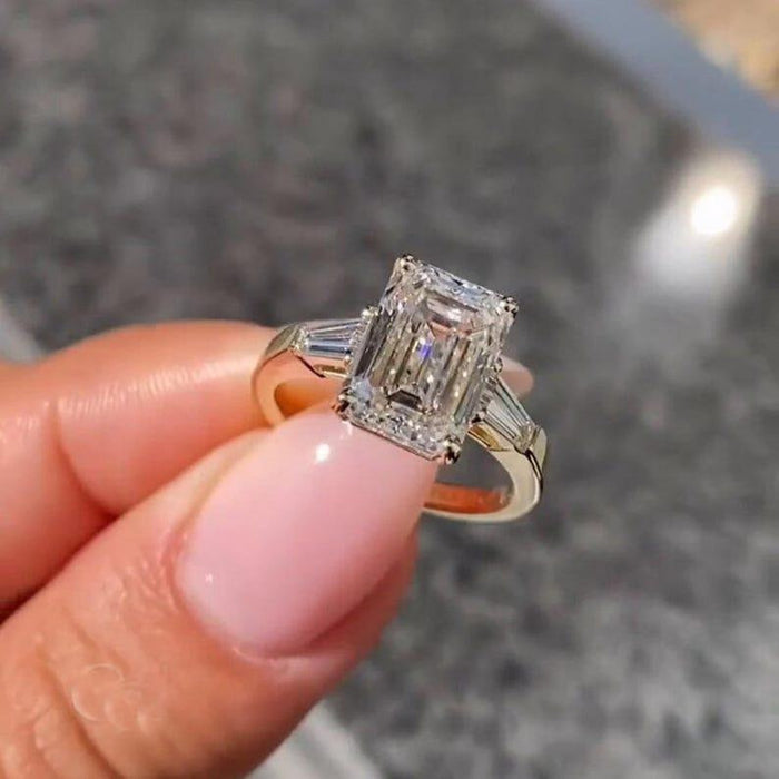Emerald cut lab grown diamond trilogy ring angled view