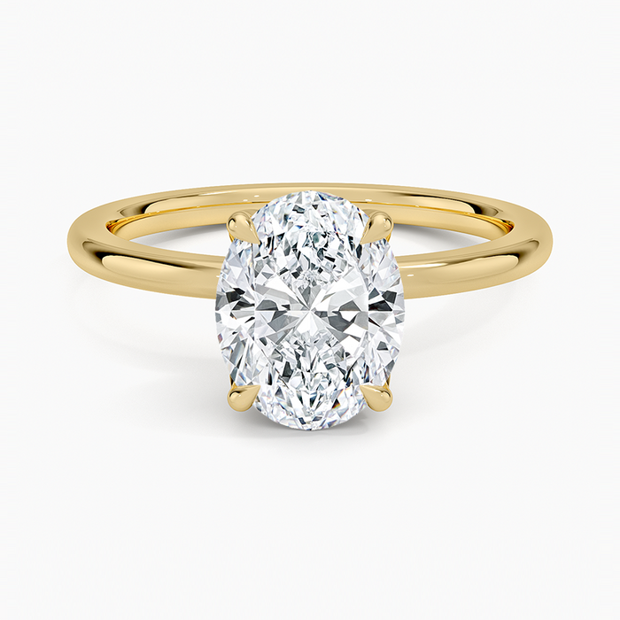 Oval cut lab grown diamond ring with a pave set lotus petal basket in yellow gold, top view
