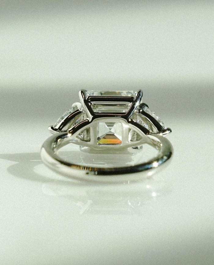 Trillion cut side stones flanking the Asscher cut lab grown diamond centre