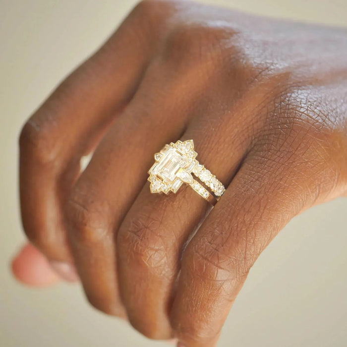 Fan shaped halo of baguettes and marquises around the emerald cut centre stone