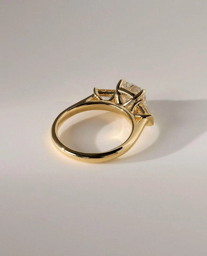 Cushion cut lab grown diamond flanked by tapered baguette side stones
