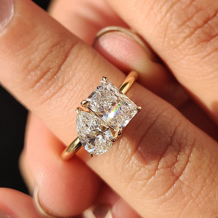 Two stone toi et moi ring with pear and radiant diamonds