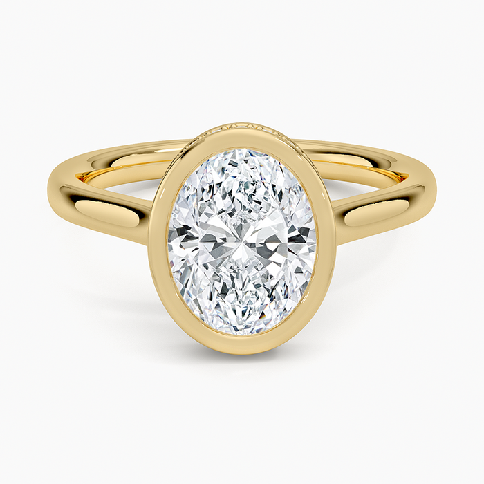 Oval cut lab grown diamond ring in a pave set bezel with milgrain rails in yellow gold, top view