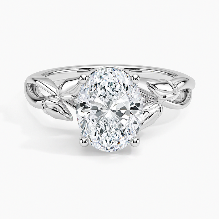 Oval cut lab grown diamond ring with sculpted metal leaves and a looping vine shank in white gold, top view