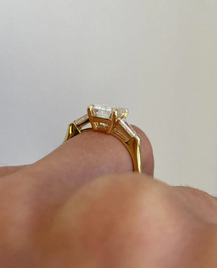Emerald cut lab grown diamond flanked by tapered baguette side stones