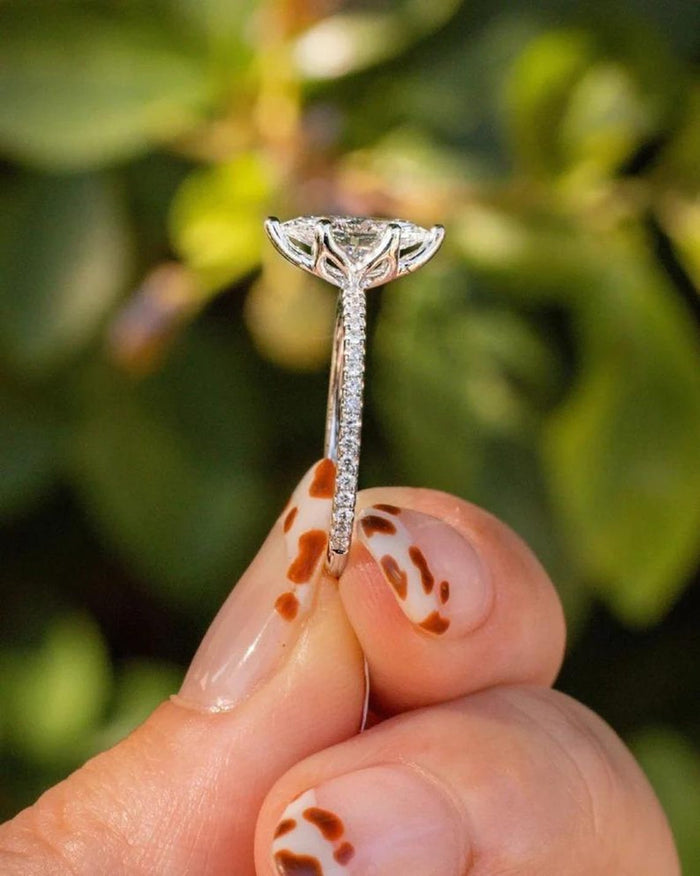 Round moissanite hidden halo engagement ring in white gold, on hand