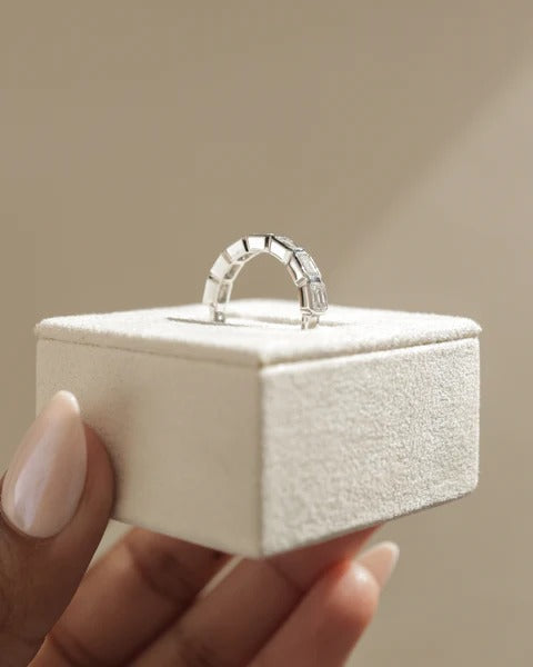 East west emerald bezel wedding band side view