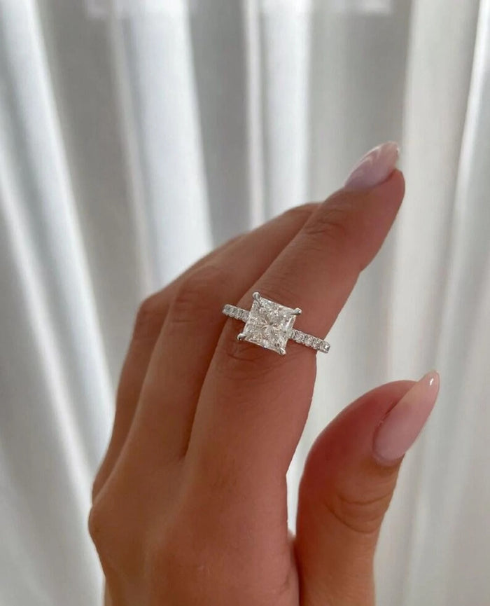 Princess cut lab grown diamond shown on the hand with pave shoulders