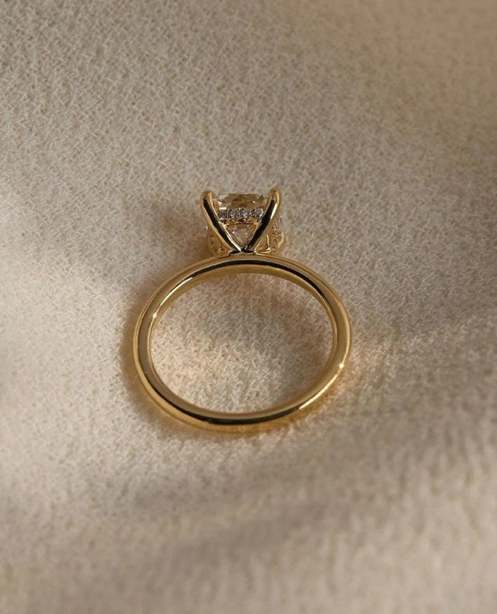 Square cushion cut lab grown diamond on a plain slim band, angled view