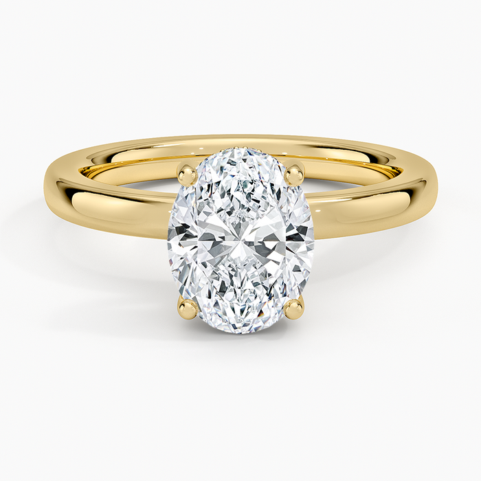 Oval cut lab grown diamond ring with a hidden halo on a rounded comfort fit band in yellow gold, top view