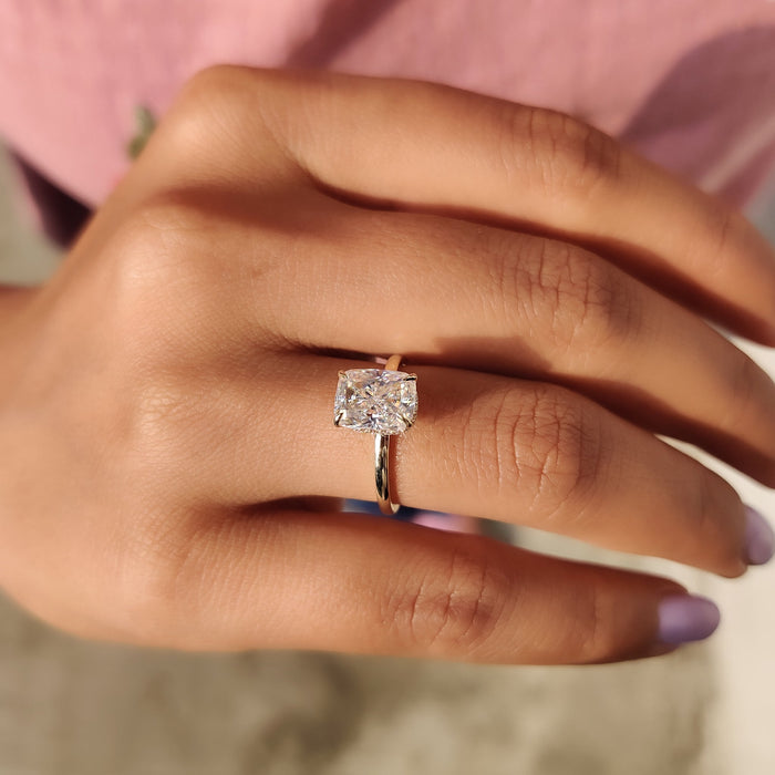 Cushion cut lab grown diamond hidden halo solitaire ring on a slim band