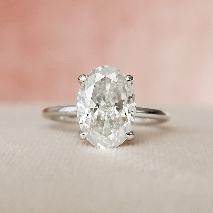 Oval cut lab grown diamond solitaire ring on a slender plain white gold band