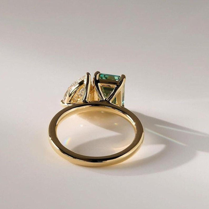 Toi et moi pear and green emerald cut lab grown diamond ring