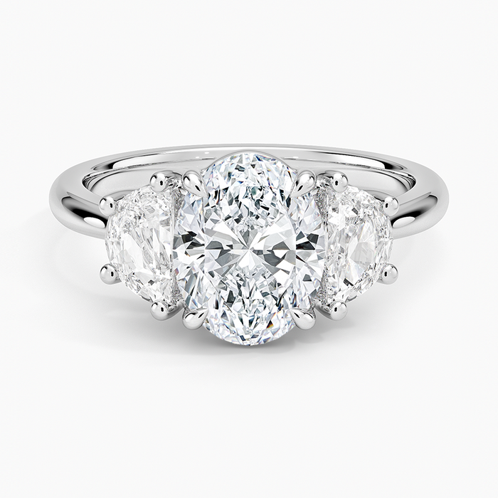 Oval cut lab grown diamond three stone ring with large half moon sides in white gold, top view
